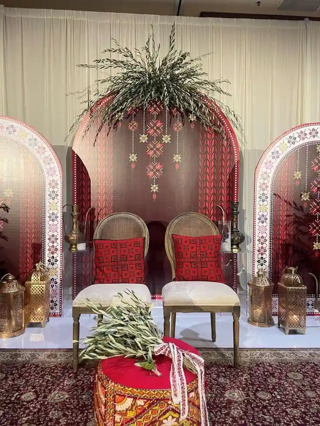 Henna night stage with embroidered arches and lanterns