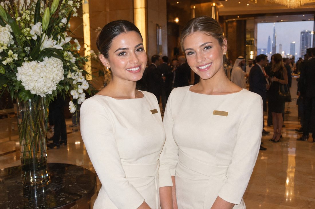 Two event hostesses smiling at the camera