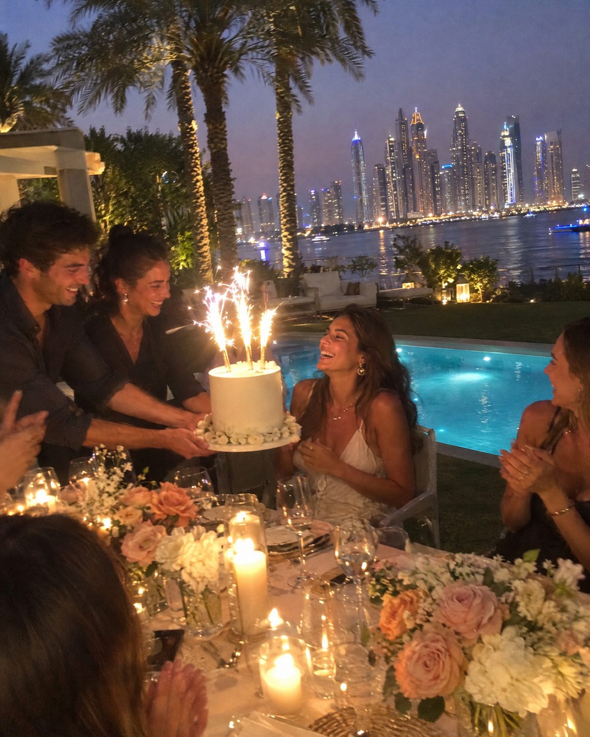 Birthday cake with sparklers at a Palm Jumeirah villa, Dubai Marina across the water